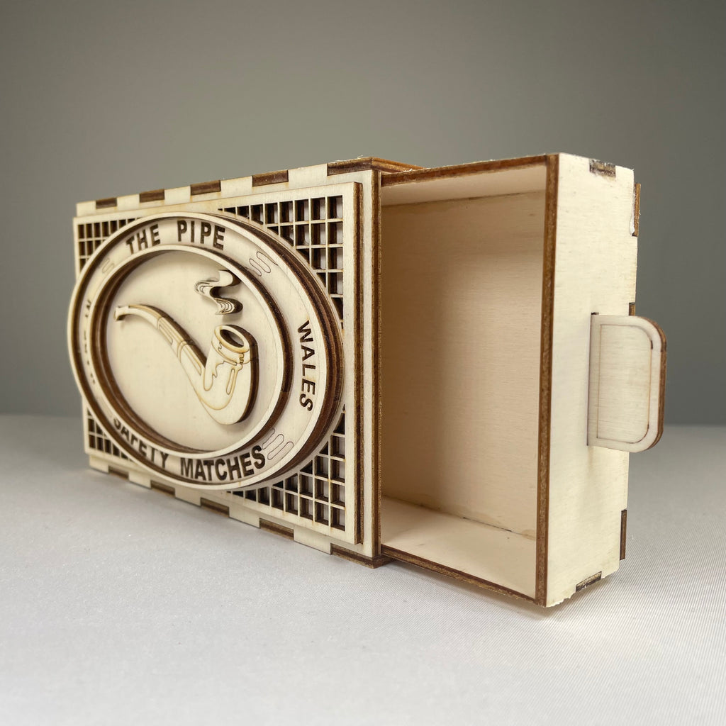 Vintage Curious Rabbit matchbox pipe flatpack model kit with detailed paper components and packaging.