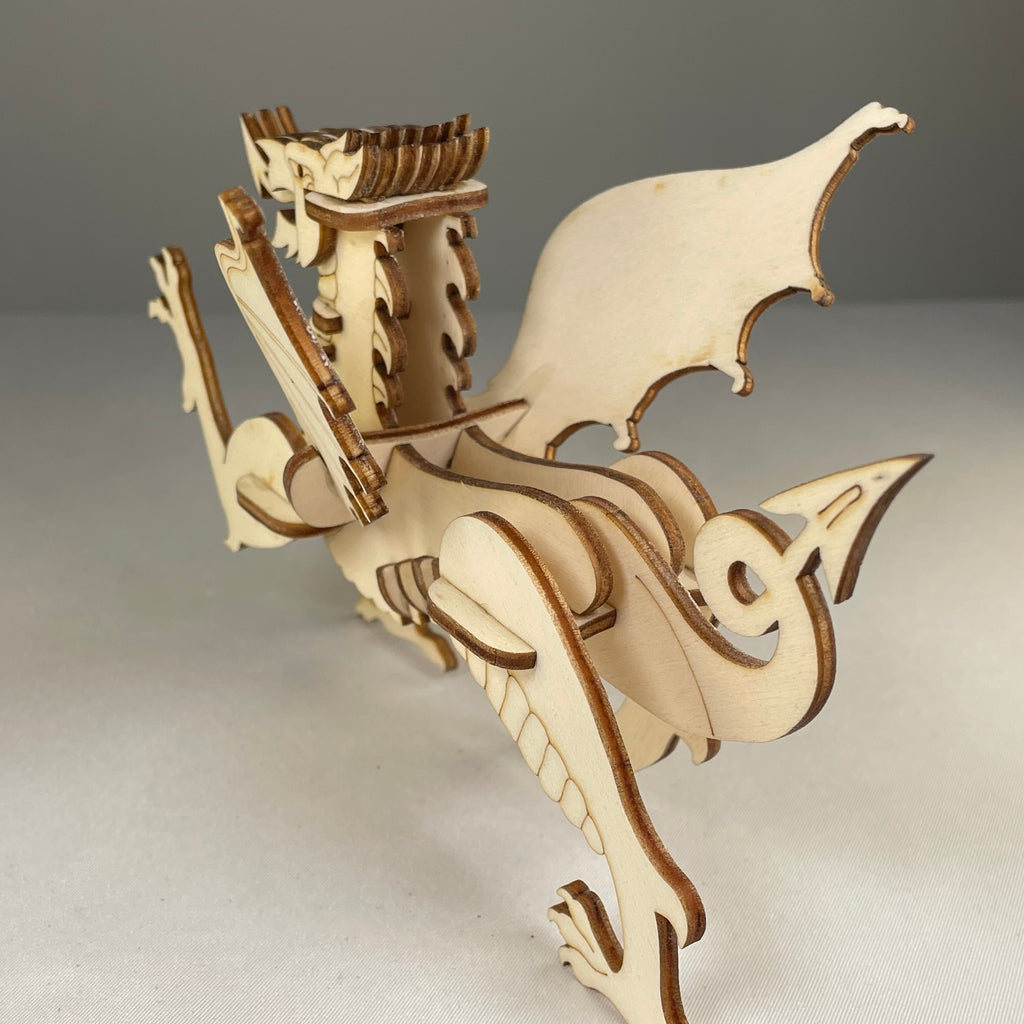 Curious Rabbit Welsh Dragon flatpack puzzle model kit featuring colorful dragon design and detailed assembly parts.