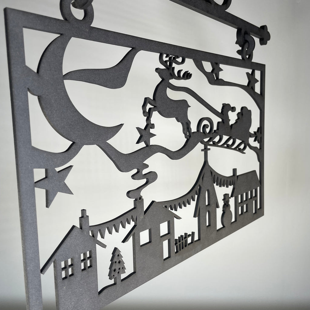 Handmade Hanging Santa Scene Christmas ornament by Curious Rabbit, featuring festive Santa figures on a decorative sign.