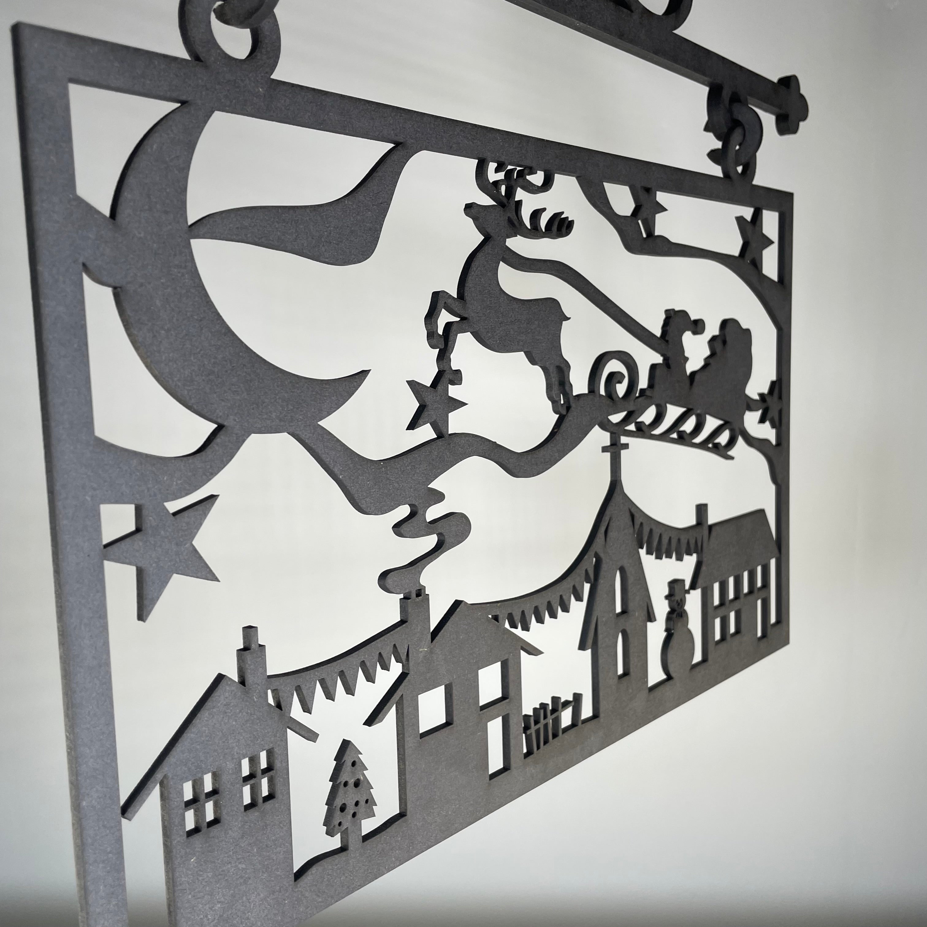 Handmade Hanging Santa Scene Christmas ornament by Curious Rabbit, featuring festive Santa figures on a decorative sign.