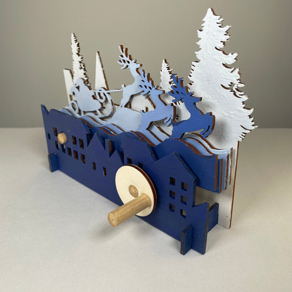 Curious Rabbit mechanical Santa sleigh flatpack Christmas model kit with detailed parts, ready for assembly.
