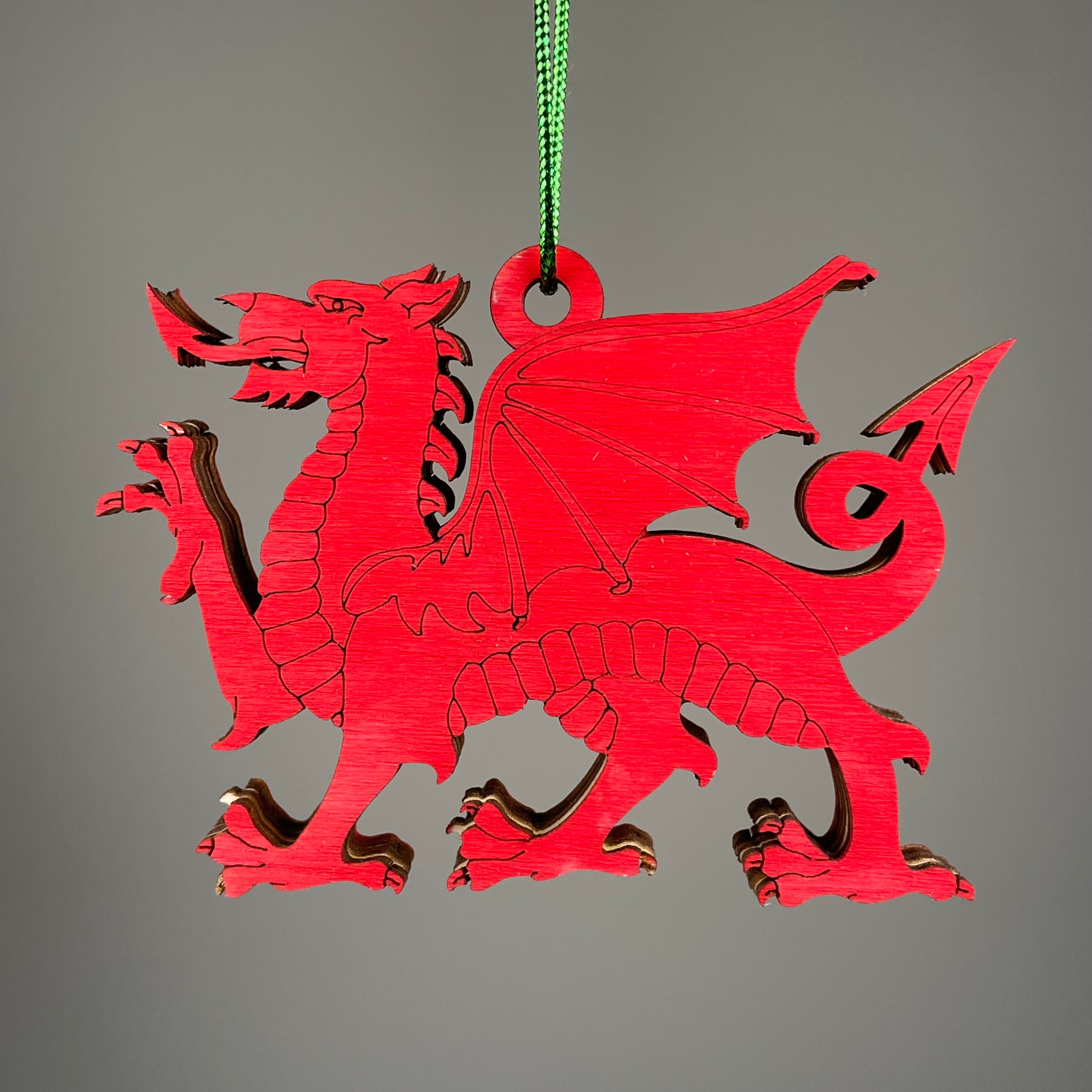 Handmade Welsh Dragon bauble from Curious Rabbit featuring a detailed ceramic ornament with vibrant red and green colors.