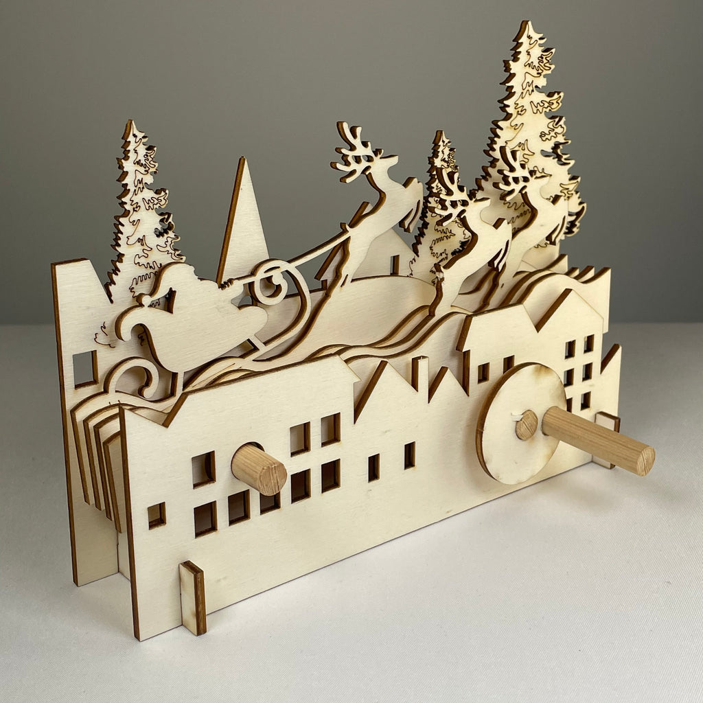 Mechanical Santa sleigh flatpack model kit by Curious Rabbit, featuring a detailed Christmas-themed mechanical design on white background.