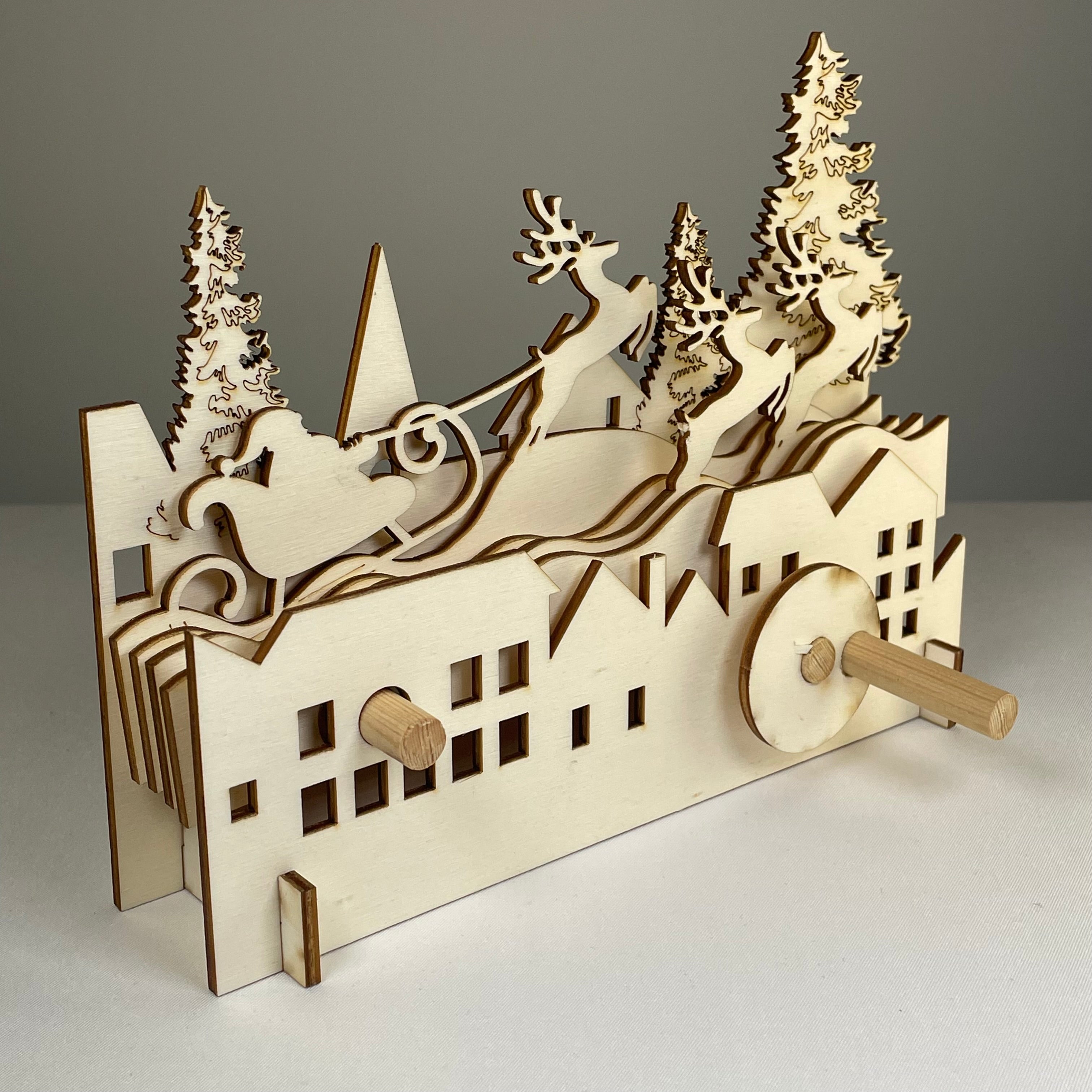 Mechanical Santa sleigh flatpack model kit by Curious Rabbit, featuring a detailed Christmas-themed mechanical design on white background.