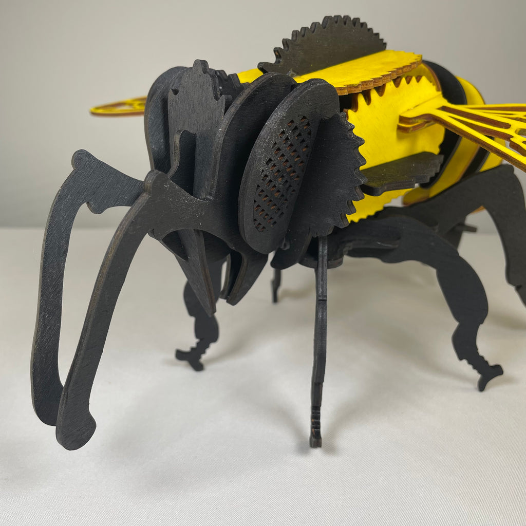 Curious Rabbit Bee Puzzle garden flatpack model kit assembled, showing a detailed bee-shaped garden decoration with vibrant colors.