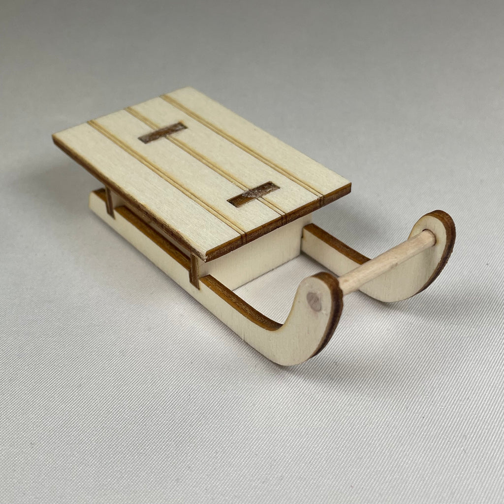 Handmade Christmas winter sledge ornament by Curious Rabbit, featuring detailed craftsmanship and festive holiday design.