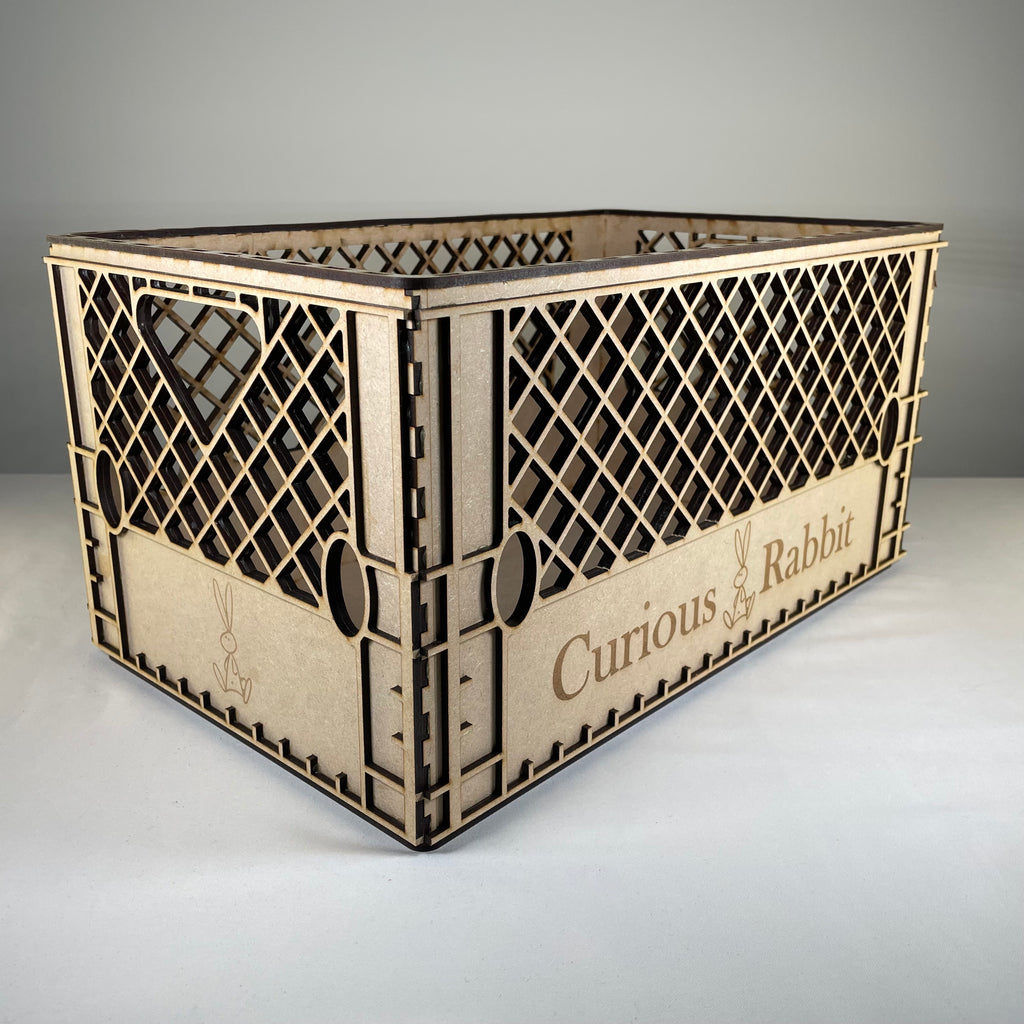 Vintage Curious Rabbit milk crate flatpack model kit showing assembled wooden crate with slatted sides and sturdy handle.
