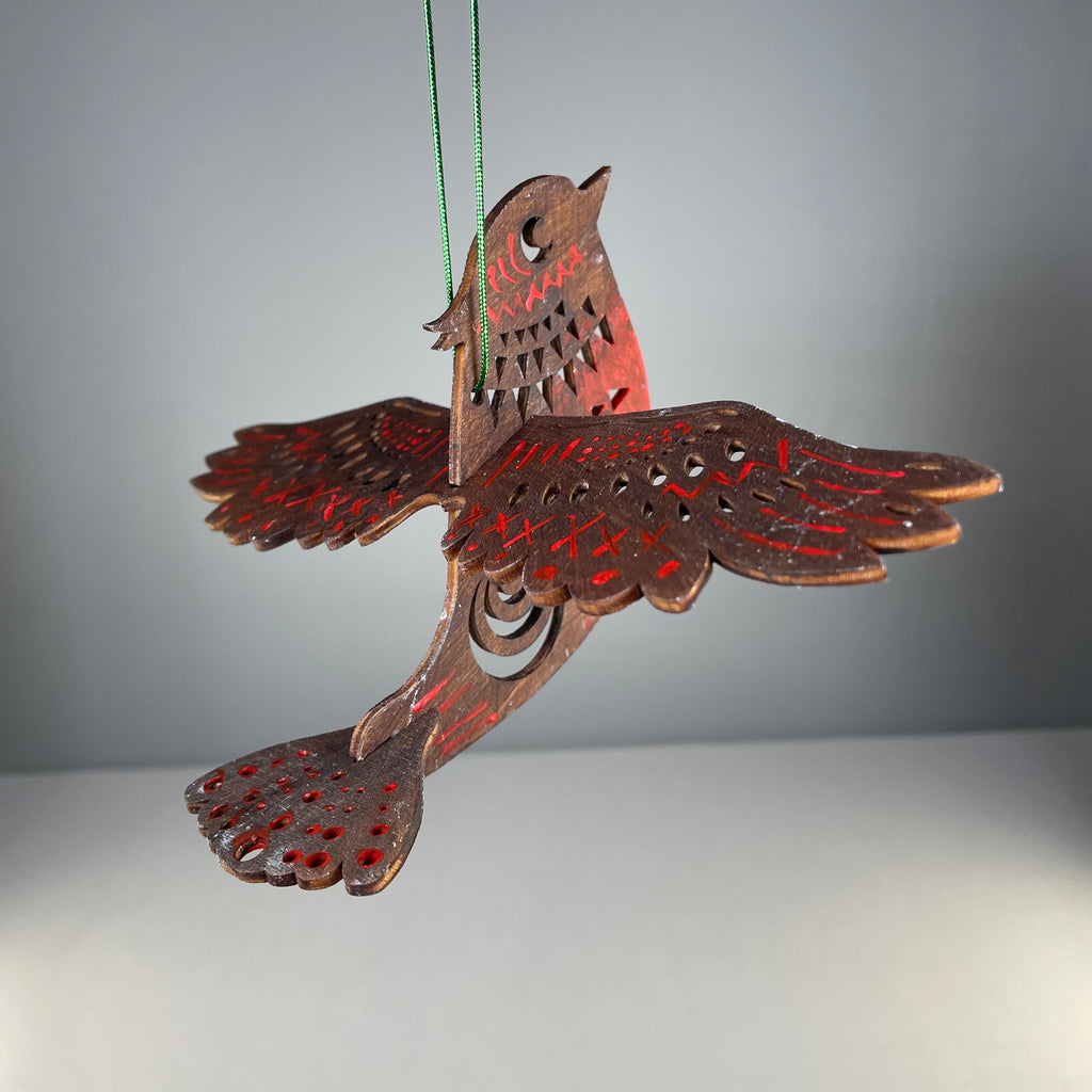 Handmade Christmas bird bauble ornament by Curious Rabbit, featuring detailed festive design on a decorative holiday ornament.