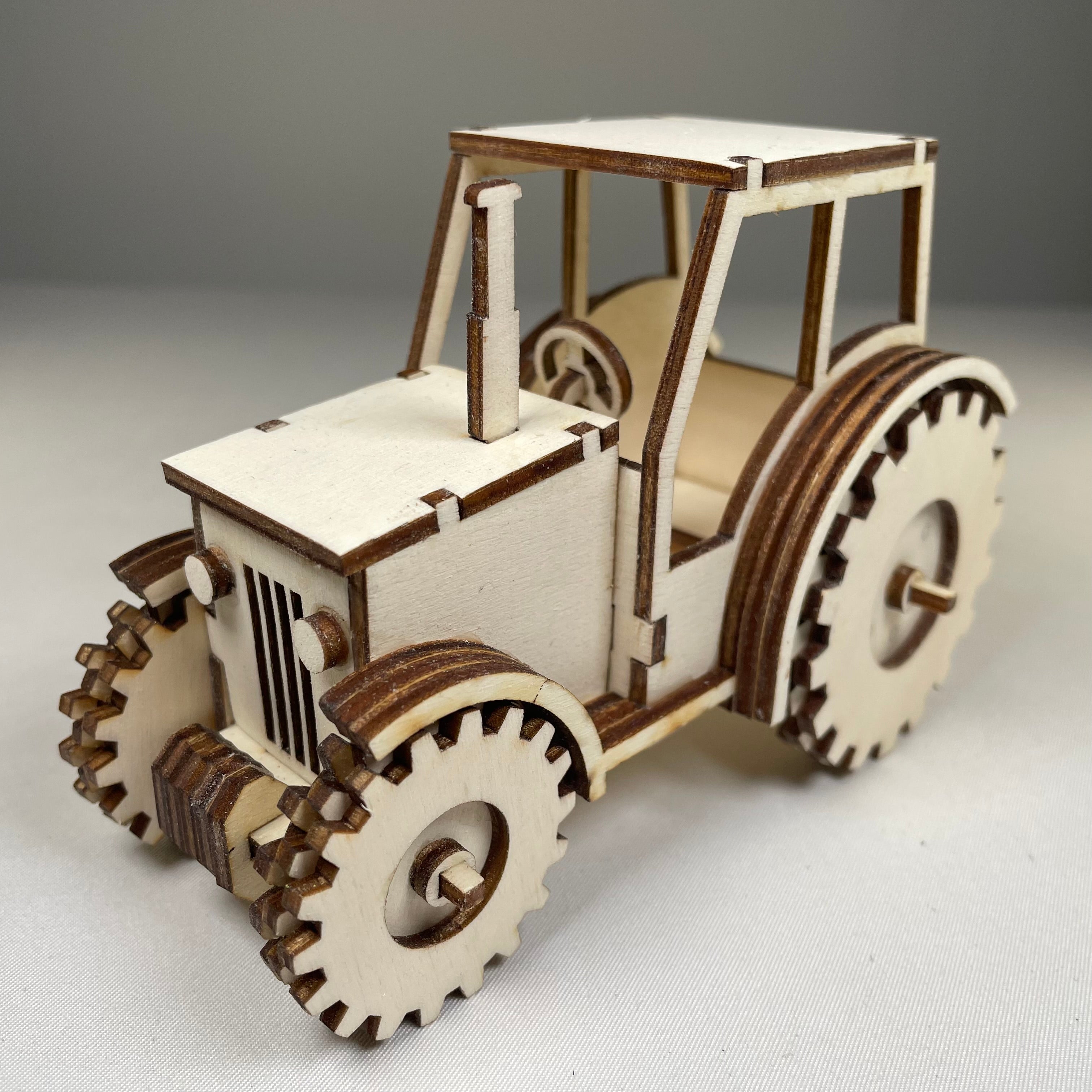 Curious Rabbit garden tractor puzzle flatpack model kit, assembled view showing colorful, detailed parts and construction details.