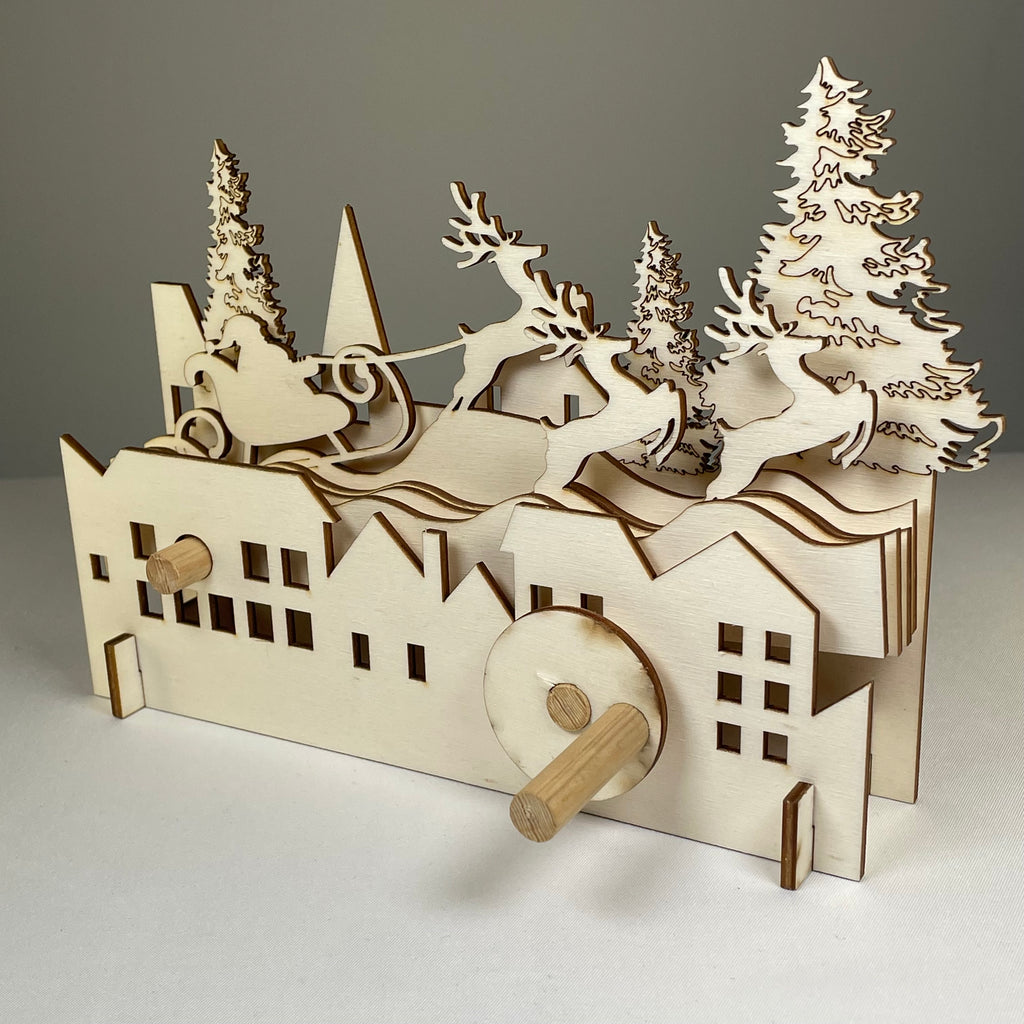Curious Rabbit mechanical Santa sleigh flatpack model kit for Christmas, assembled with intricate details and festive holiday design.