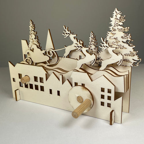Curious Rabbit mechanical Santa sleigh flatpack model kit for Christmas, assembled with intricate details and festive holiday design.