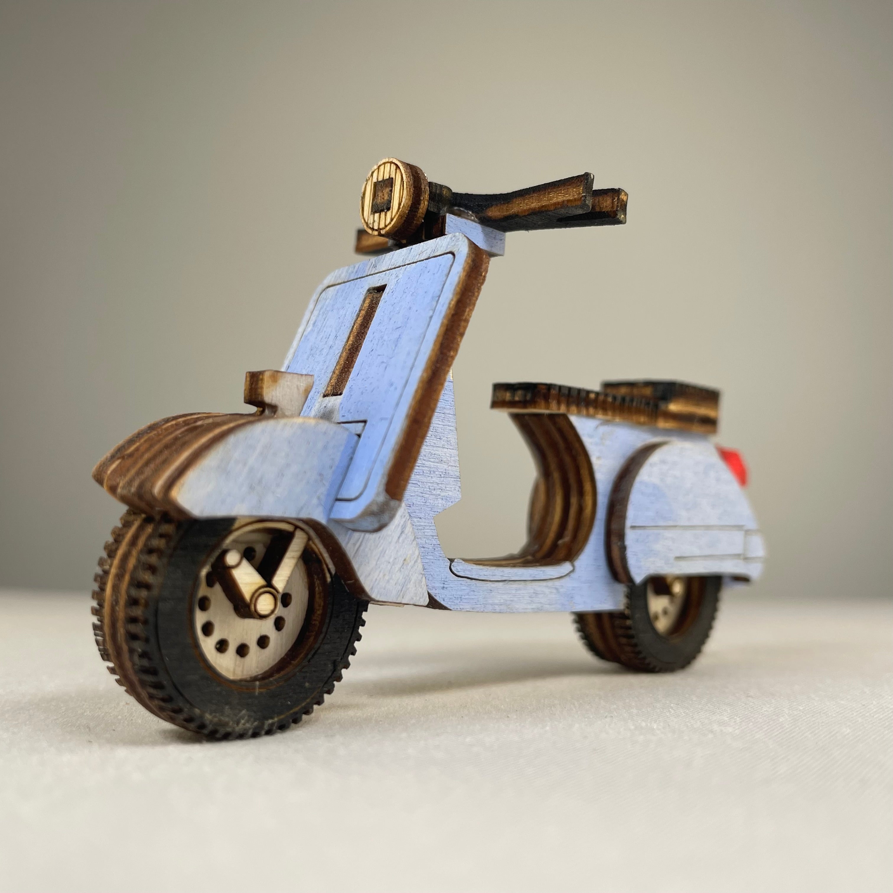 Vintage Curious Rabbit Retro Scooter flatpack model kit assembled, showcasing a detailed miniature of a classic scooter.