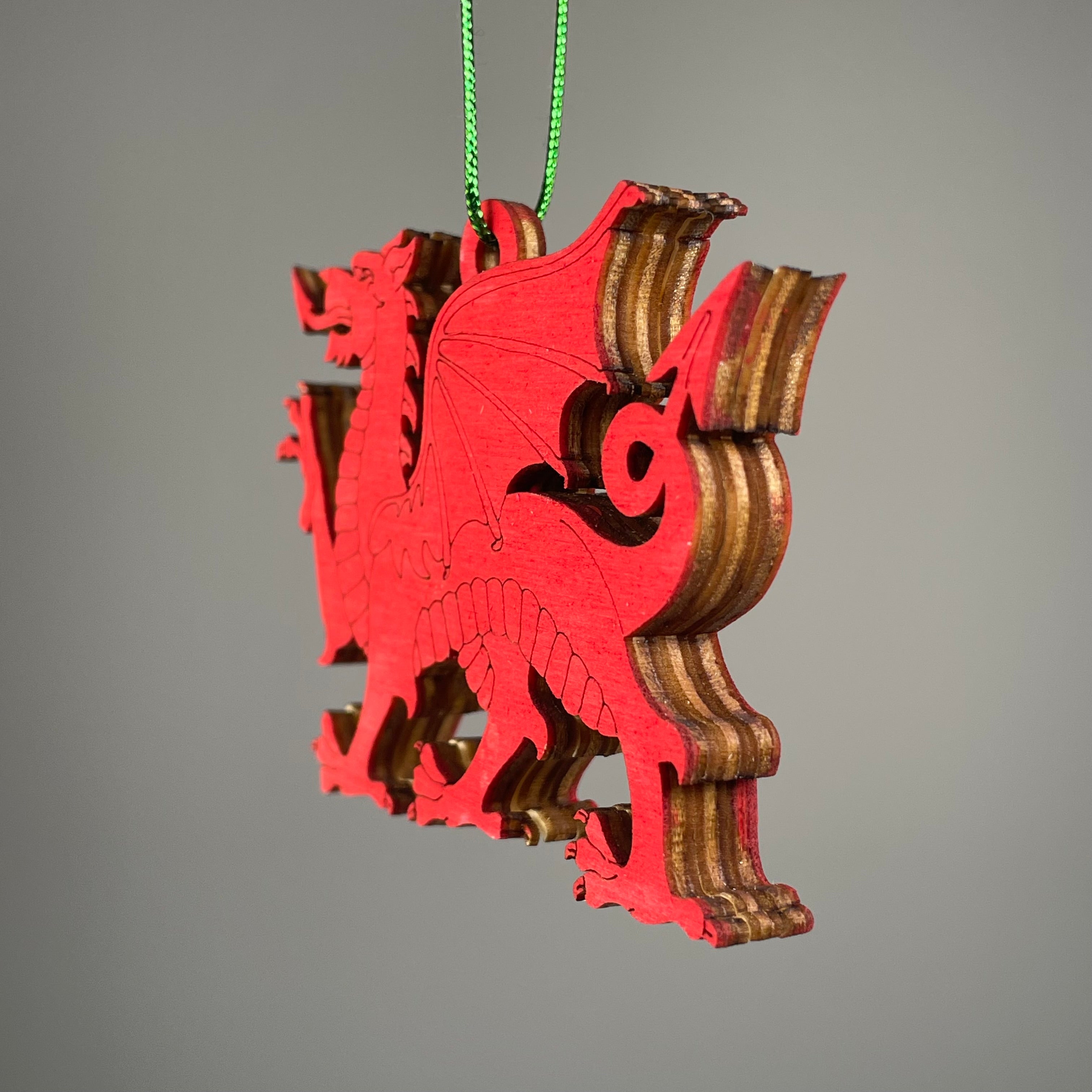 Handmade Welsh Dragon Bauble ornament by Curious Rabbit, featuring a colorful Welsh dragon design on a festive holiday decoration.