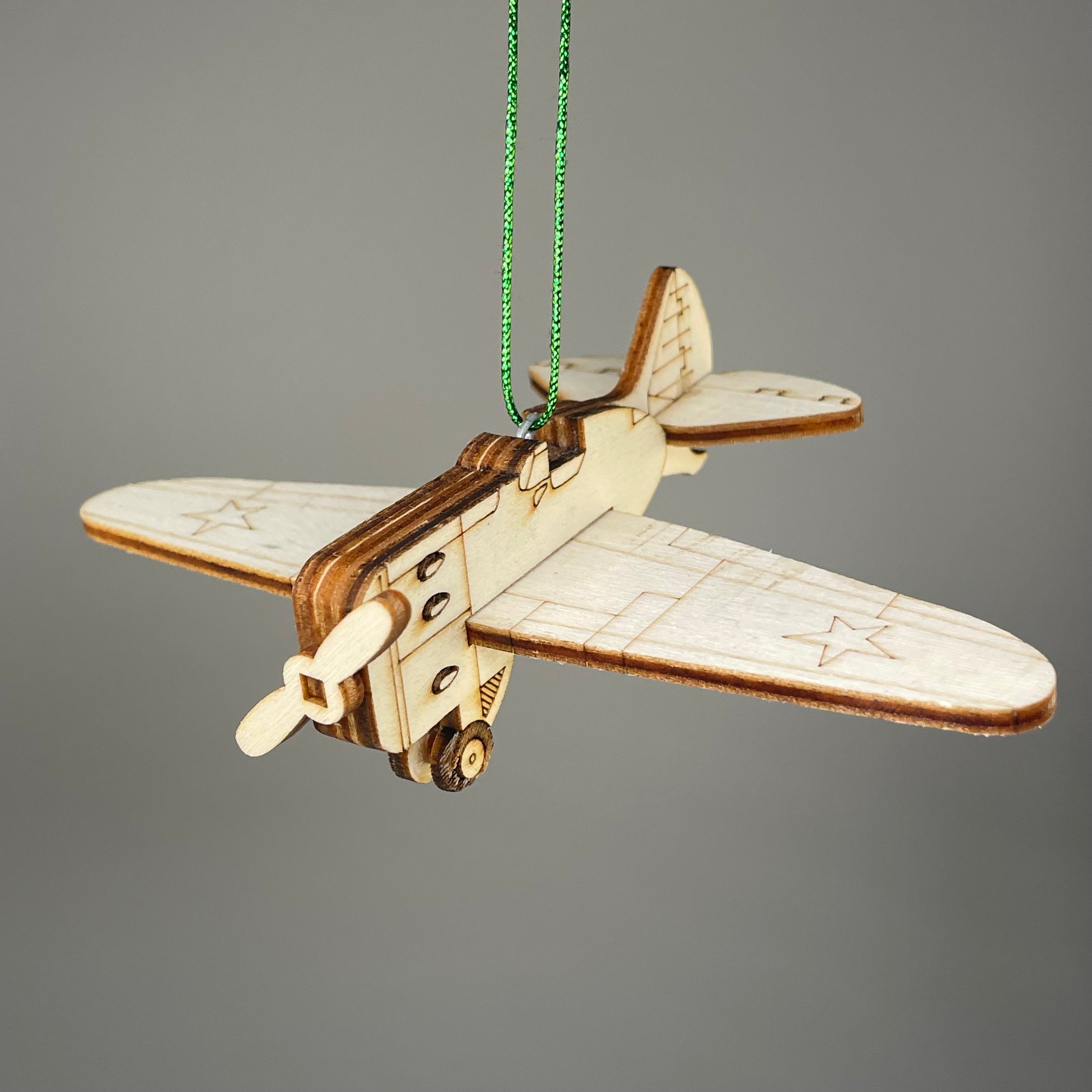 Handmade plane-shaped bauble ornament by Curious Rabbit, featuring detailed craftsmanship and vintage-inspired design for holiday decor.