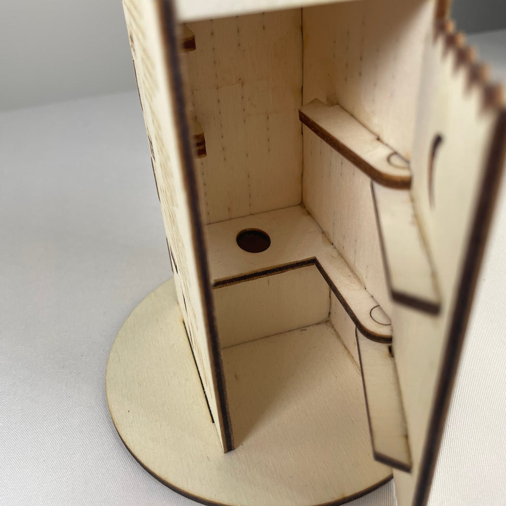 Curious Rabbit Outhouse Toilet flatpack memo holder with architecture design, shown assembled on a white background.