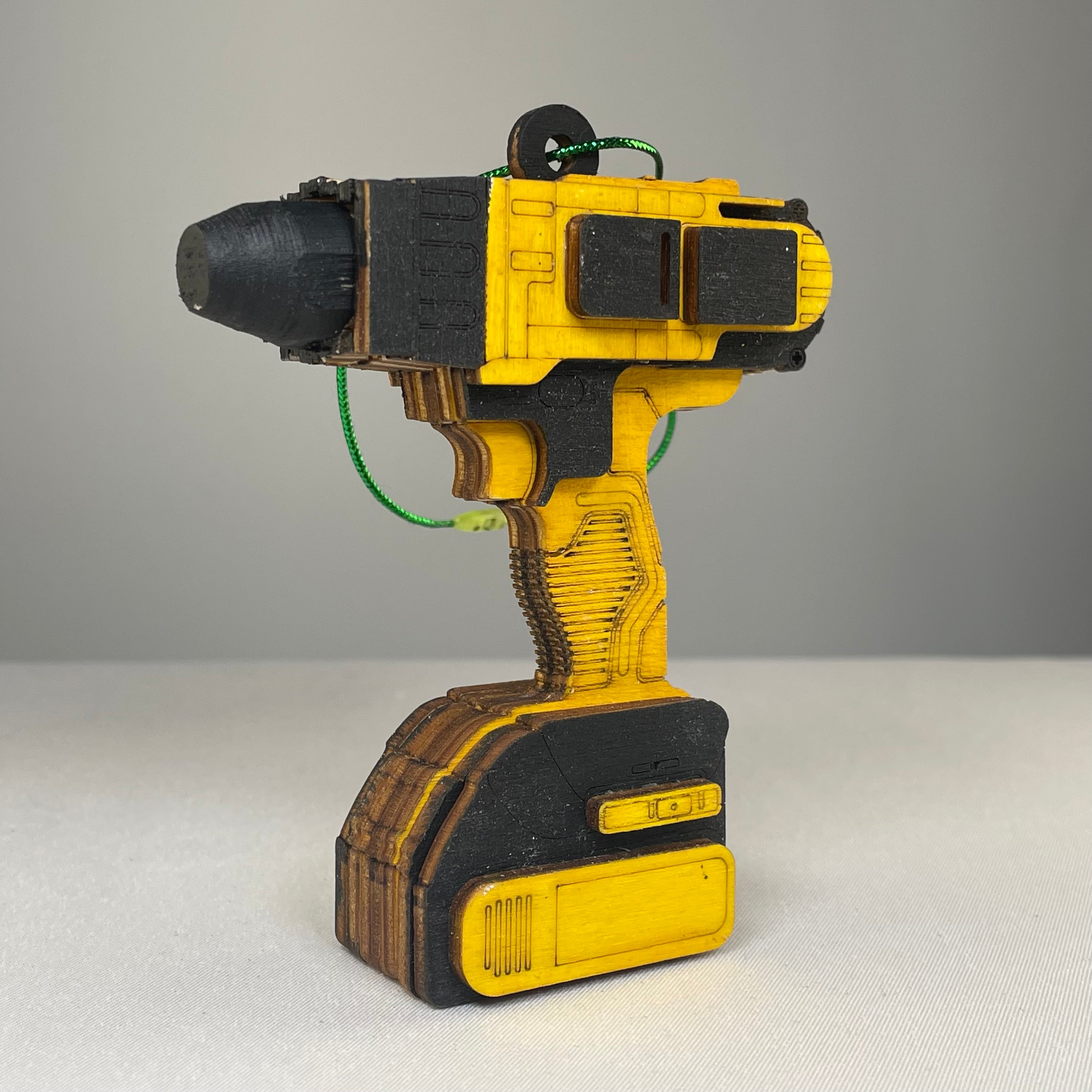 Handmade Curious Rabbit toolbox ornament shaped like a power drill bauble, detailed and colorful for decorative display