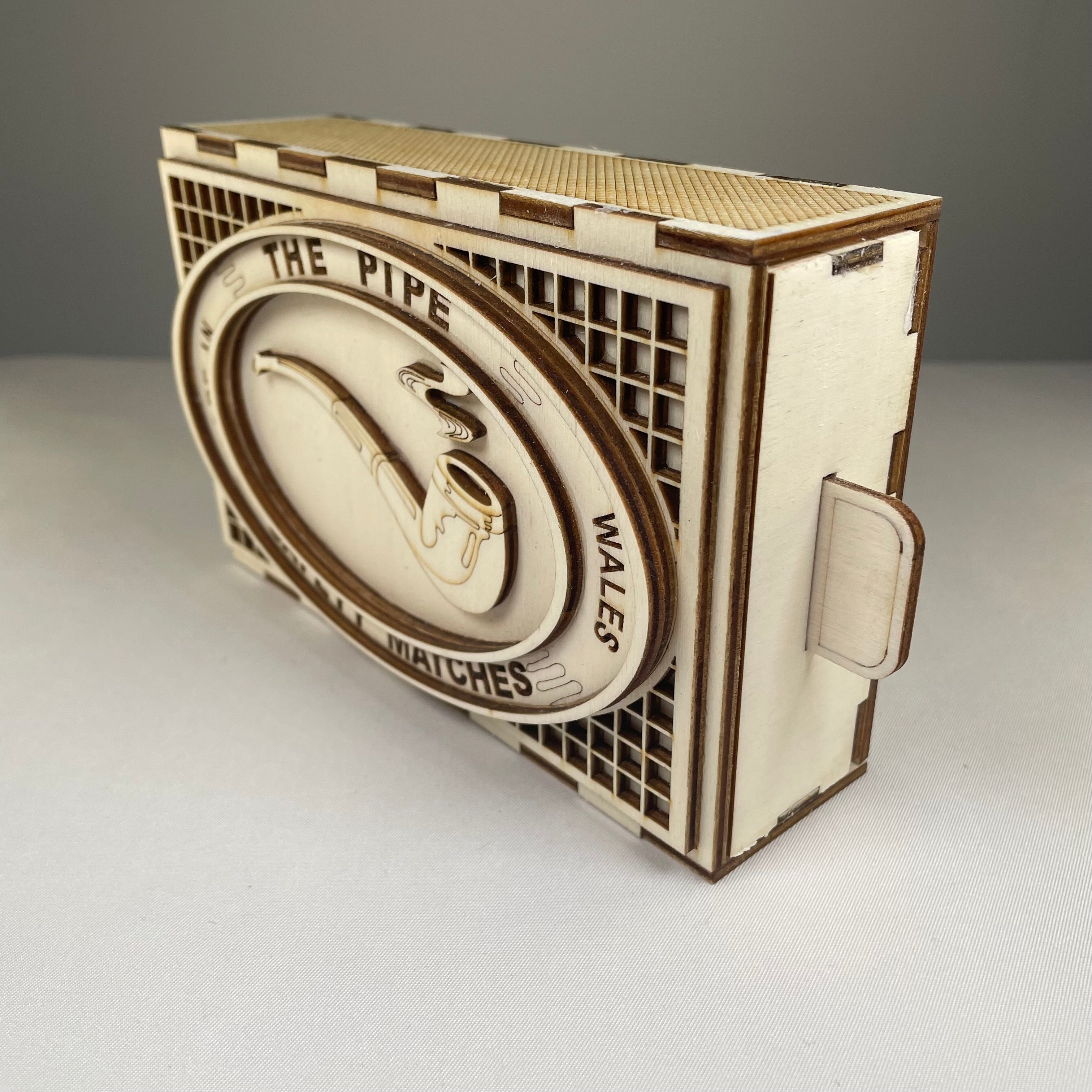 Vintage Curious Rabbit matchbox pipe flatpack model kit with assembled and unassembled parts on a white background.