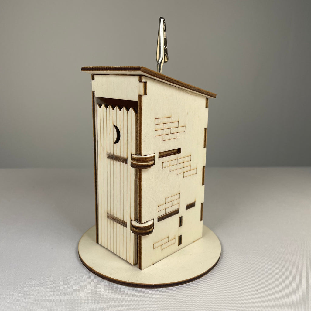 Curious Rabbit Outhouse Toilet flatpack memo holder featuring architecture design, made for desk or office organization.