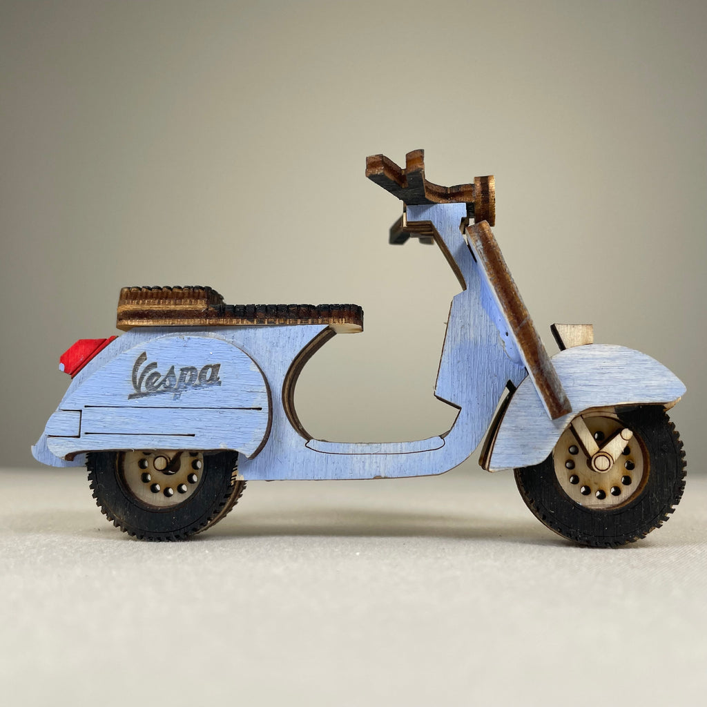 Vintage retro scooter flatpack model kit by Curious Rabbit, showing assembled miniature scooter with detailed vintage design.