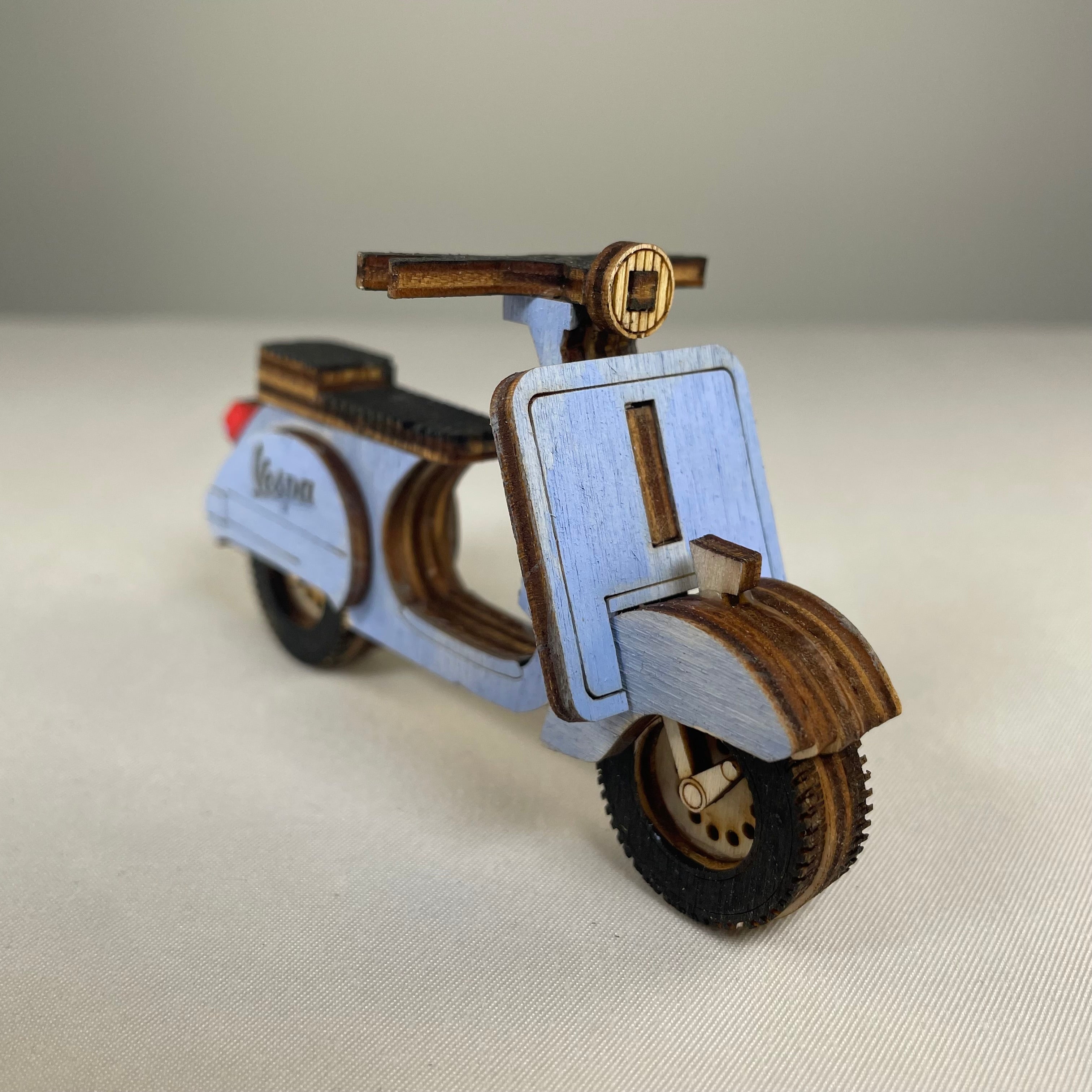 Vintage Retro Scooter flatpack model kit by Curious Rabbit, assembled with detailed parts and vibrant colors.