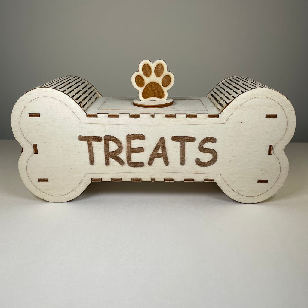 Curious Rabbit flatpack dog treat box kit for pets, shown assembled with treats inside, natural wood finish and compact design.