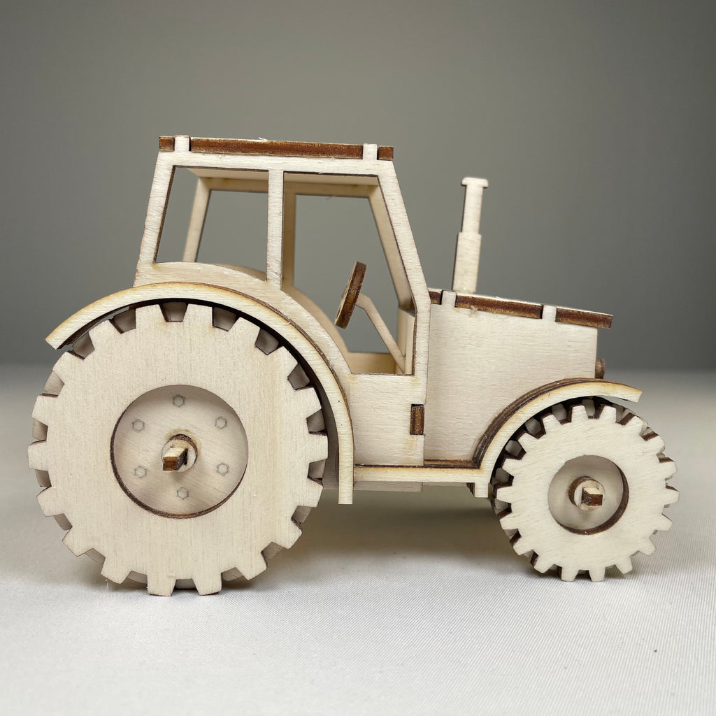 Garden tractor puzzle by Curious Rabbit, flatpack model kit showing detailed assembled tractor for children and hobbyists.