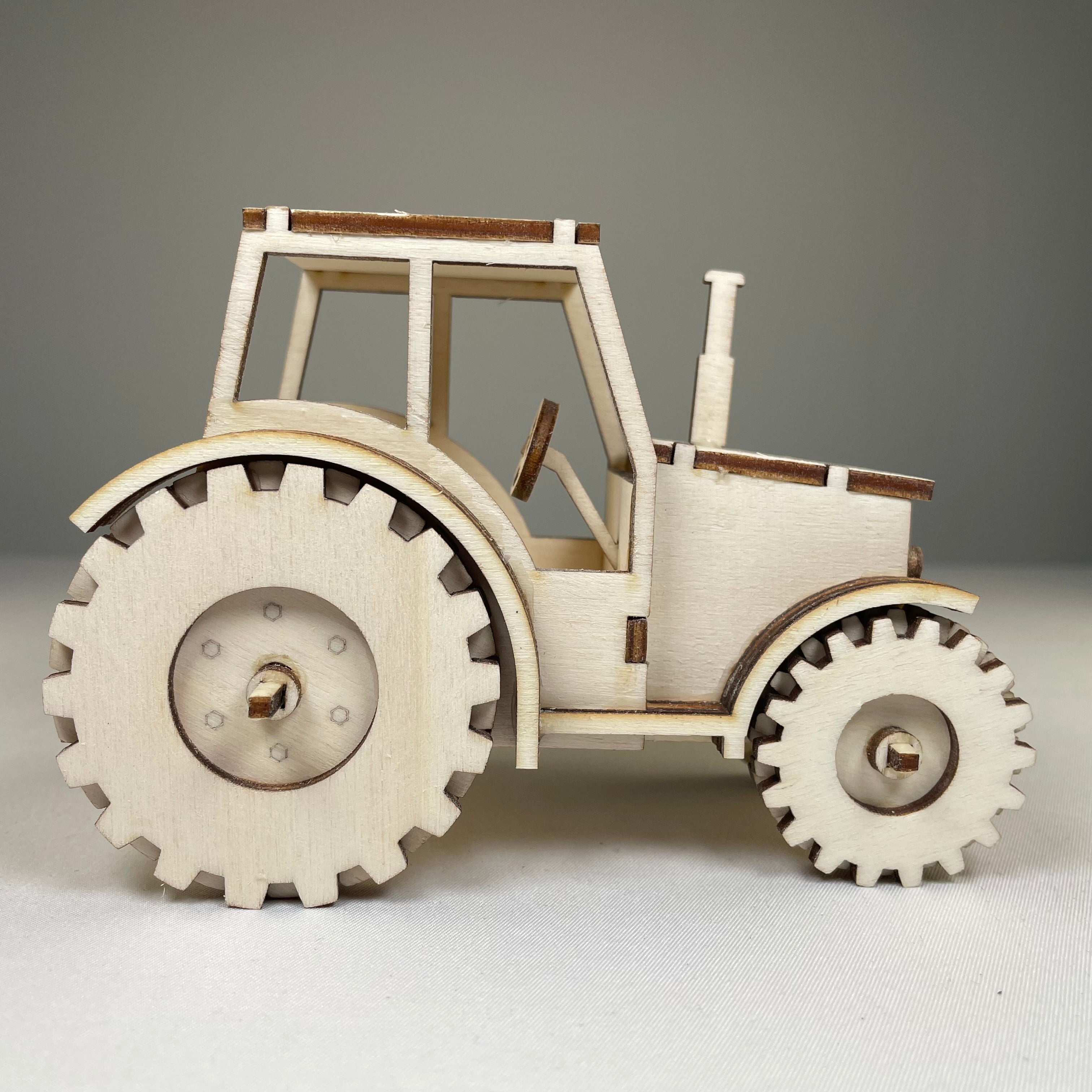 Garden tractor puzzle by Curious Rabbit, flatpack model kit showing detailed assembled tractor for children and hobbyists.