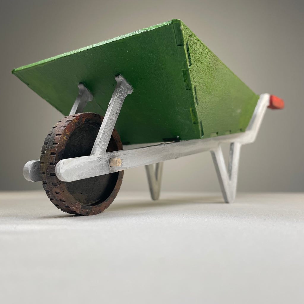 Curious Rabbit wheelbarrow planter garden kit with flatpack design, featuring a miniature wheelbarrow shape for outdoor planting.