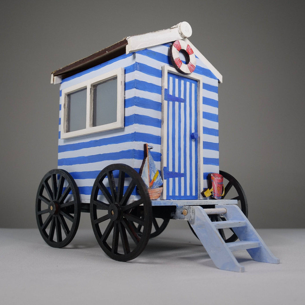 Curious Rabbit Beach Bathing Hut Flatpack Model Kit, showing assembled miniature beach hut with open door and bright colors.
