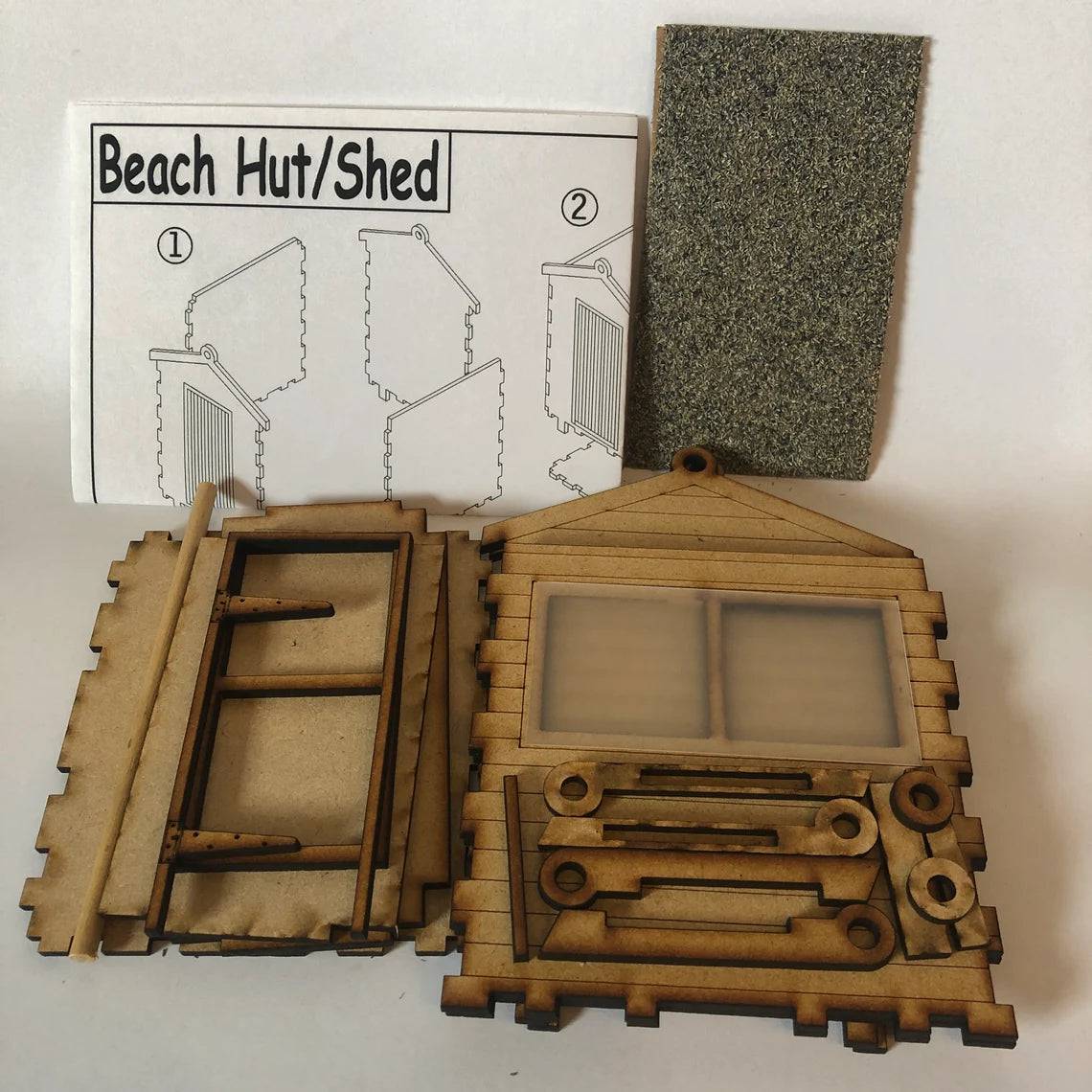 Curious Rabbit beach hut flatpack model kit, detailed miniature beach hut with open door and windows, perfect for craft enthusiasts.