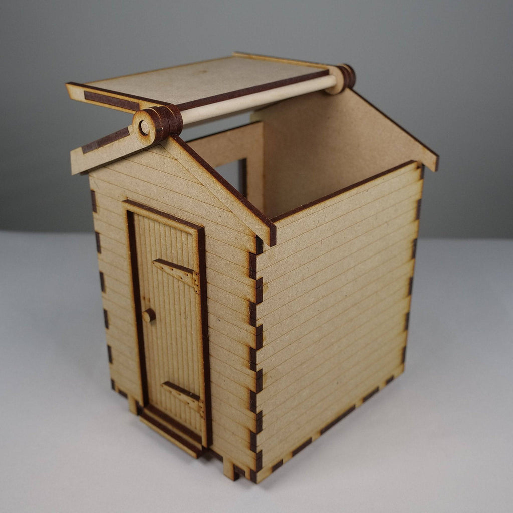 Curious Rabbit garden shed flatpack model kit with assembled wooden panels and door, designed for outdoor storage.