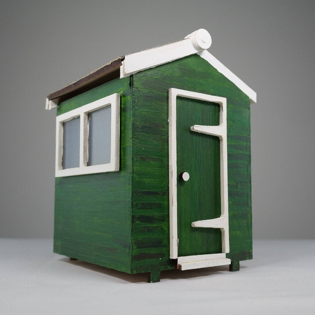 Curious Rabbit garden shed flatpack model kit with assembled wooden panels and roof, ready for outdoor garden storage and organization.