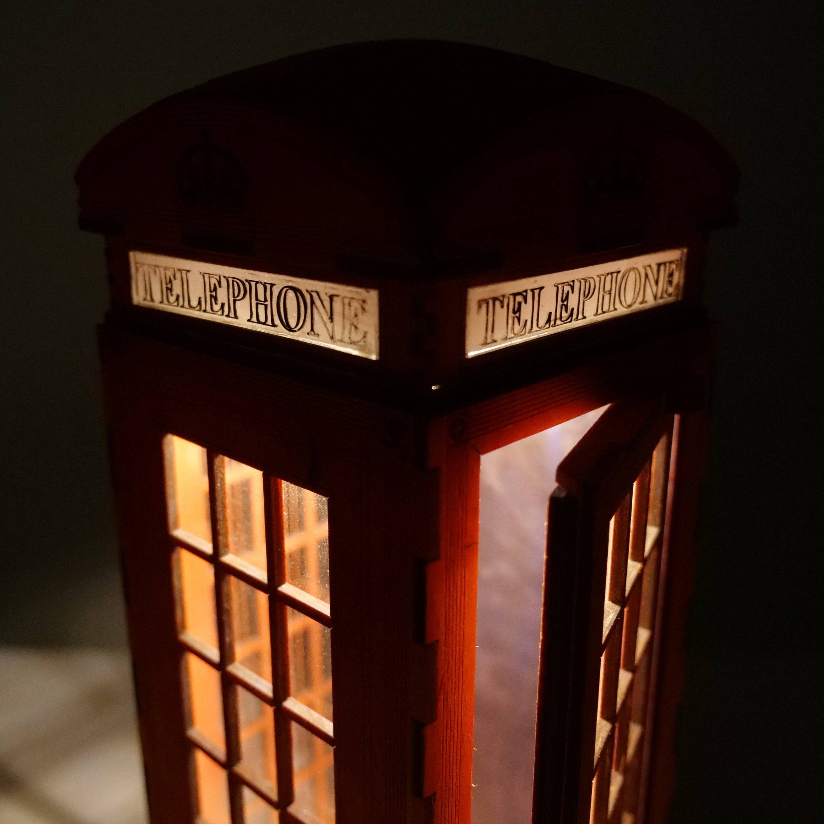 Curious Rabbit Telephone Box Lamp icon in flatpack model kit, featuring a classic red British telephone box design.