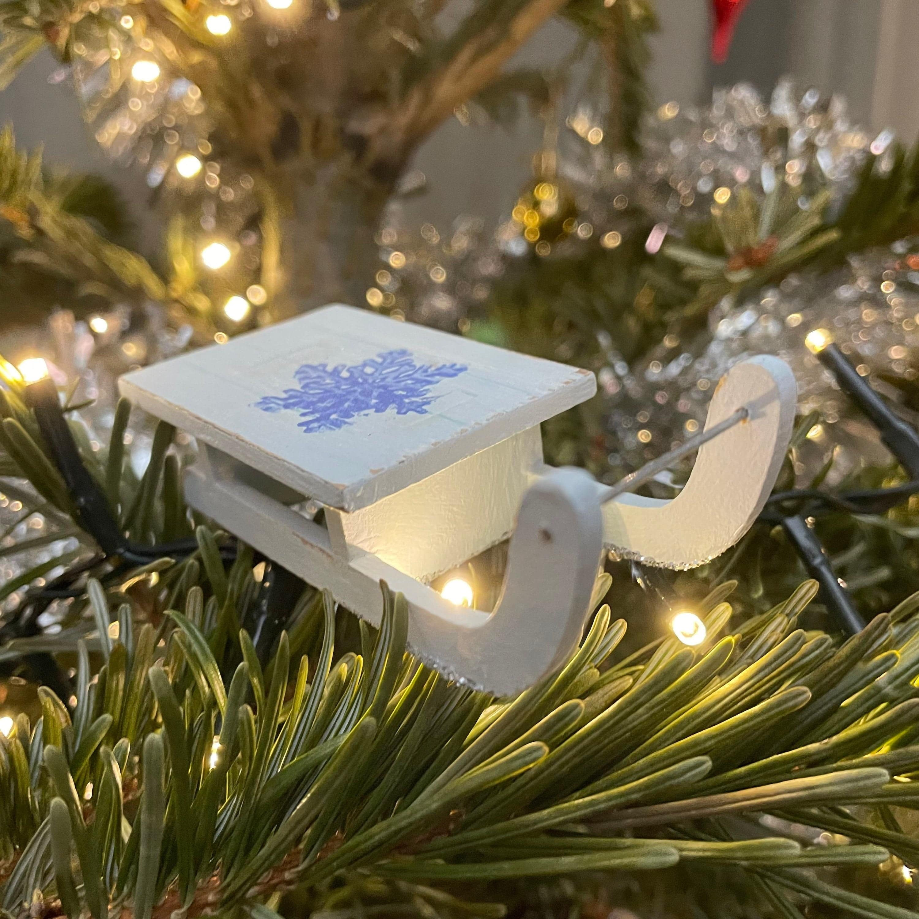 Rustic handmade Christmas sledge bauble by Curious Rabbit, decorative winter ornament with festive holiday details.