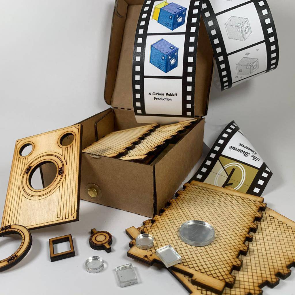 Vintage Brownie Camera flatpack model kit by Curious Rabbit, showing assembled brown camera with detailed features and packaging.